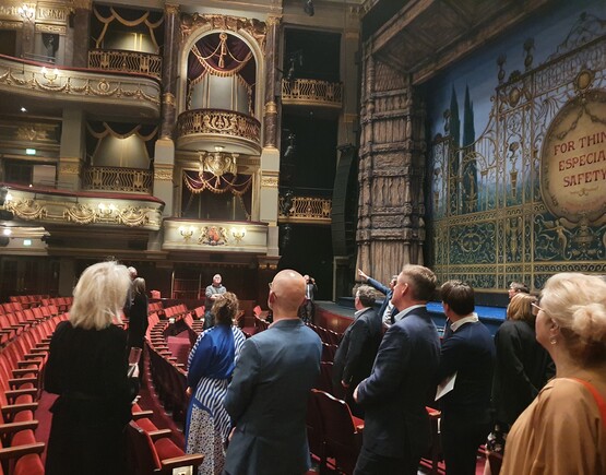 Group of people admiring a historic theatre auditorium