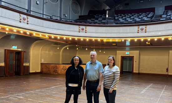 Two women and a man stood in Leith Theatre auditorium.